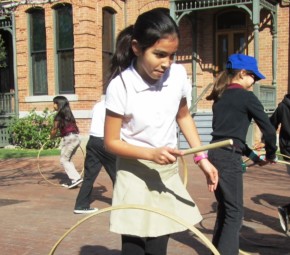 Children playing 19th century games outside Rosson House during at Heritage Square field trip.