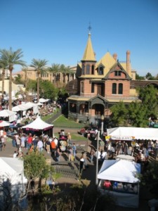 Picture of a festival at Heritage Square, with people and tents surrounding Rosson House.