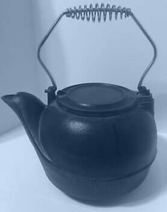 A black cast iron tea pot.