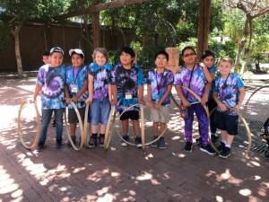 Group of students smiling after playing games during a Heritage Square field trip.
