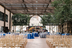 Chairs set up for a wedding at Heritage Square's Lath Pavilion, with tables and a food truck in the back ground for the reception.
