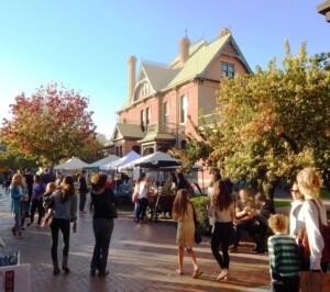 A festival with tents at Heritage Square, with Rosson House in the background.