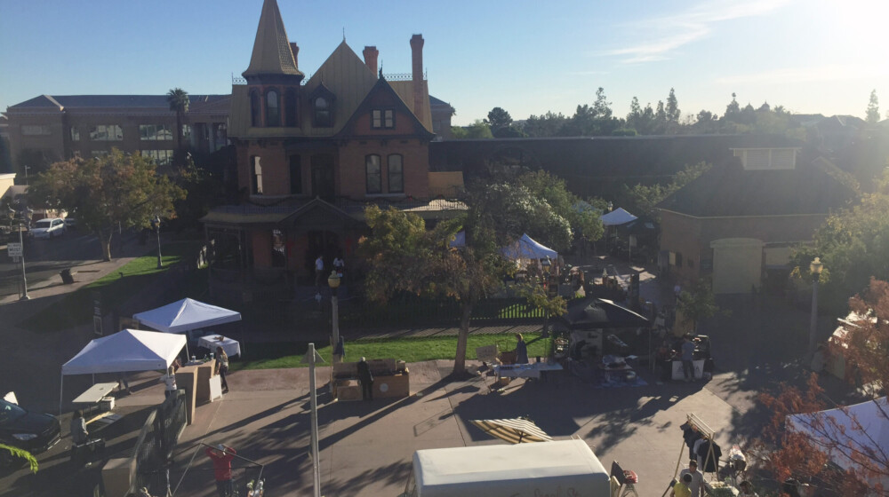 A festival at historic Heritage Square, with Rosson House in the background.