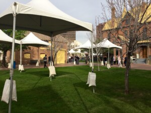 Festival tents set up in the grassy area of Heritage Square.