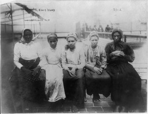 Black and white picture of five immigrant women at Ellis Island, circa 1910.