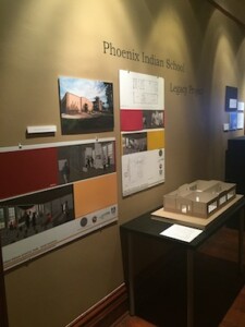 A picture of the exhibit title, which reads, "Phoenix Indian School Legacy Project", and a model of the building that was the Phoenix Indian School band building.
