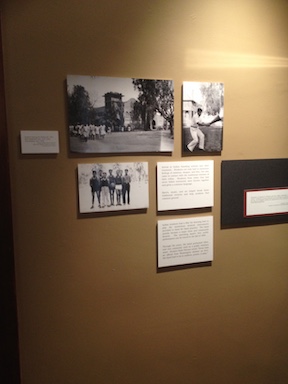 An exhibit wall from the Phoenix Indian School Legacy Project, showcasing students from the Phoenix Indian School and pictures of the school itself.