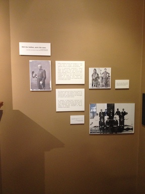 An exhibit wall from the Phoenix Indian School Legacy Project, showcasing students from the Phoenix Indian School.