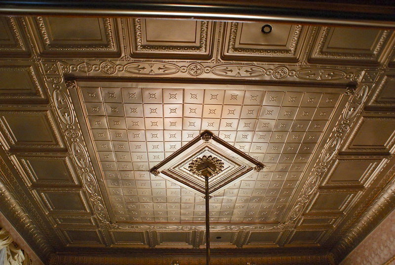 The ornamental metal ceiling in the Rosson House formal parlor, painted with gold-colored paint.