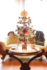 A picture of a Victorian-style table top Christmas tree, in the family parlor at Rosson House.