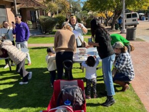 A picture of families doing crafts and activities on the front lawn of the Museum Store at Heritage Square.
