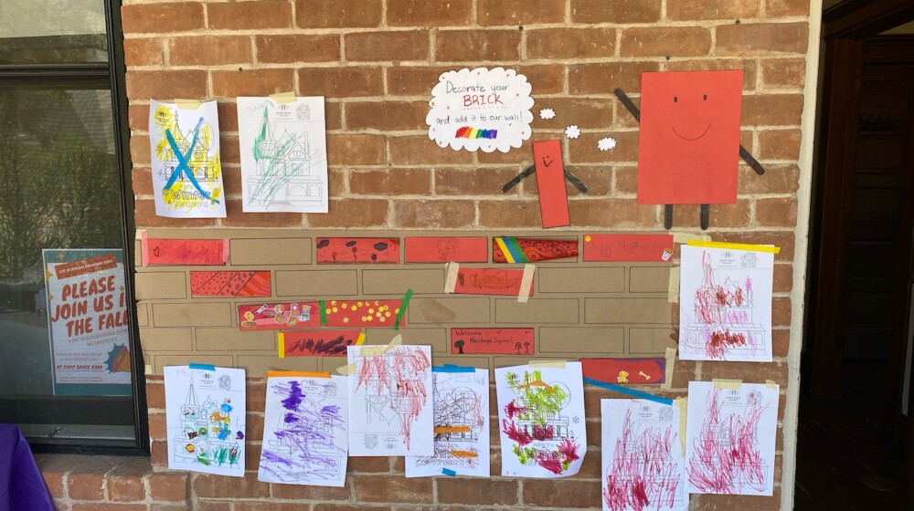 A picture of a kids' craft set up in front of a brick wall.