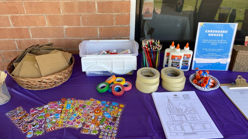 A picture of crafting supplies set up on a table with a brick wall background.