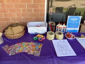 A picture of crafting supplies set up on a table with a brick wall background.