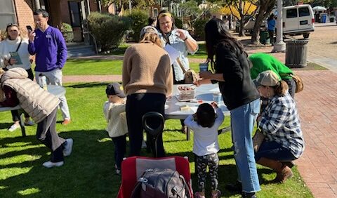A picture of families doing crafts on the lawn at Heritage Square.