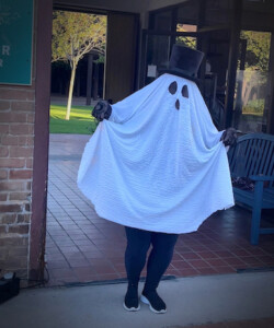 A picture of someone dressed up like a ghost for Halloween at Heritage Square with a sheet and tophat.