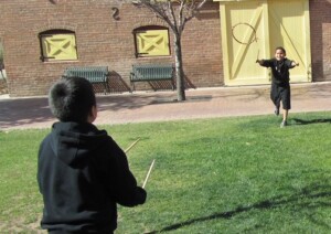 A picture of two boys playing a lawn game at Heritage Square.