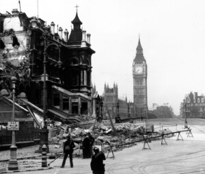 A black and white picture of the iconic London clock, Big Ben, during World War two, with bomb damage in the foreground.
