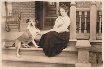 A picture of Mrs. Higley and the family dog on the front steps at Rosson House.