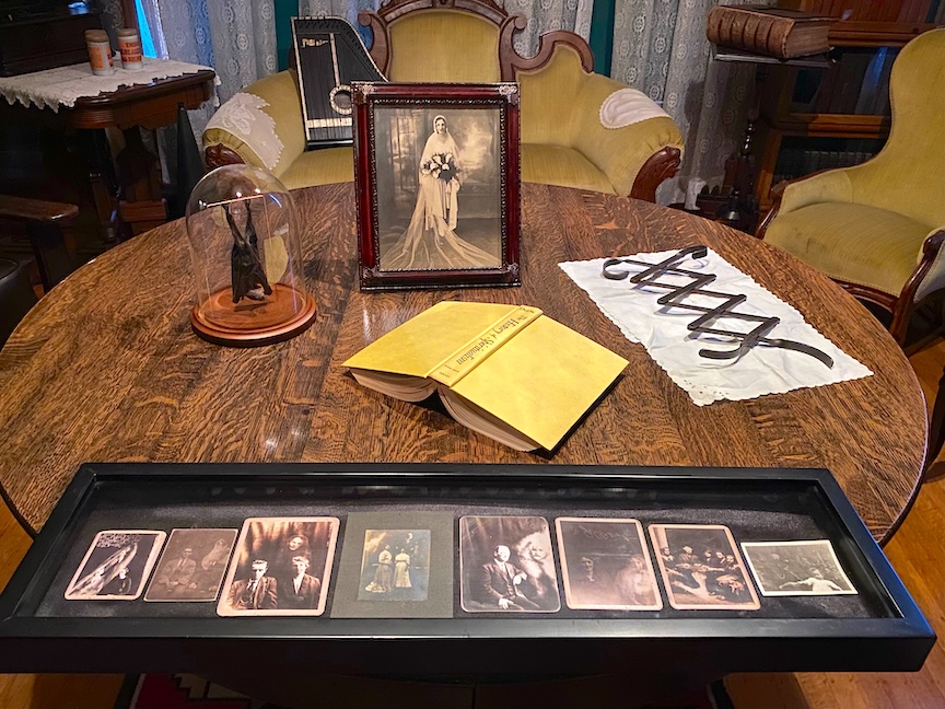 A picture of a table in Rosson House Museum with historic artifacts on display.