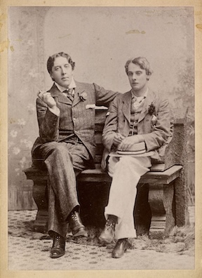 A photograph in sepia tones of Oscar Wilde and his lover, Lord Alfred Douglas.